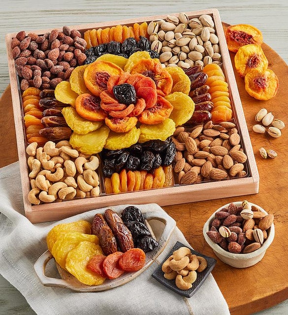 A wooden tray filled with nuts and dried fruits